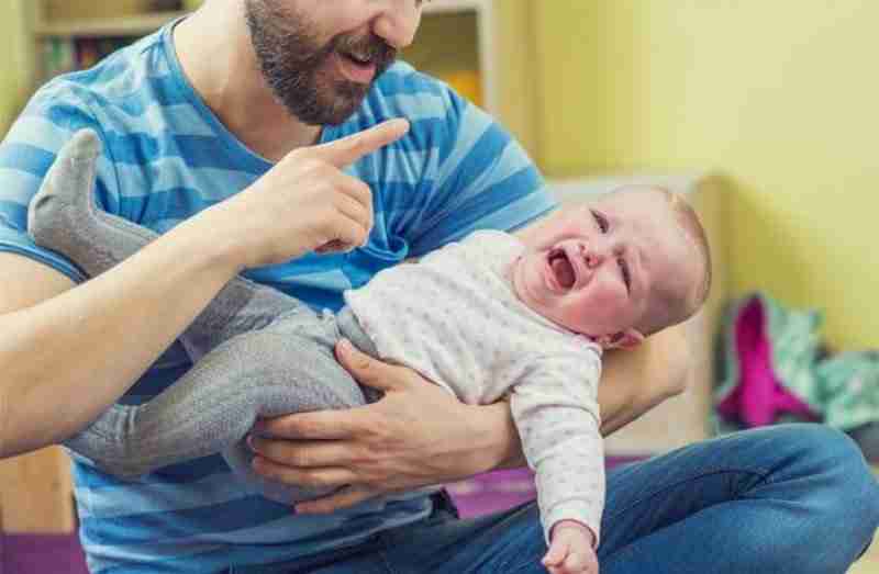 father with crying infant baby